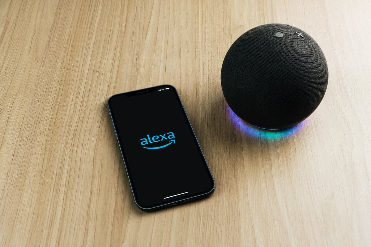 Alexa, Smart speaker and virtual assistant from Amazon company connected to smartphone app. Wooden background. Rio de Janeiro, RJ, Brazil. September 2021